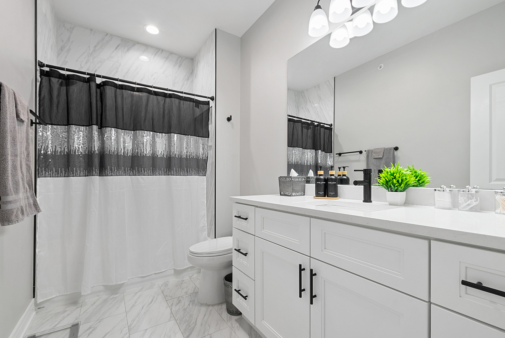 7727 South Roberts Road Bridgeview, IL 60455 - Photo 25 of 36 a bathroom with a sink a toilet and mirror
