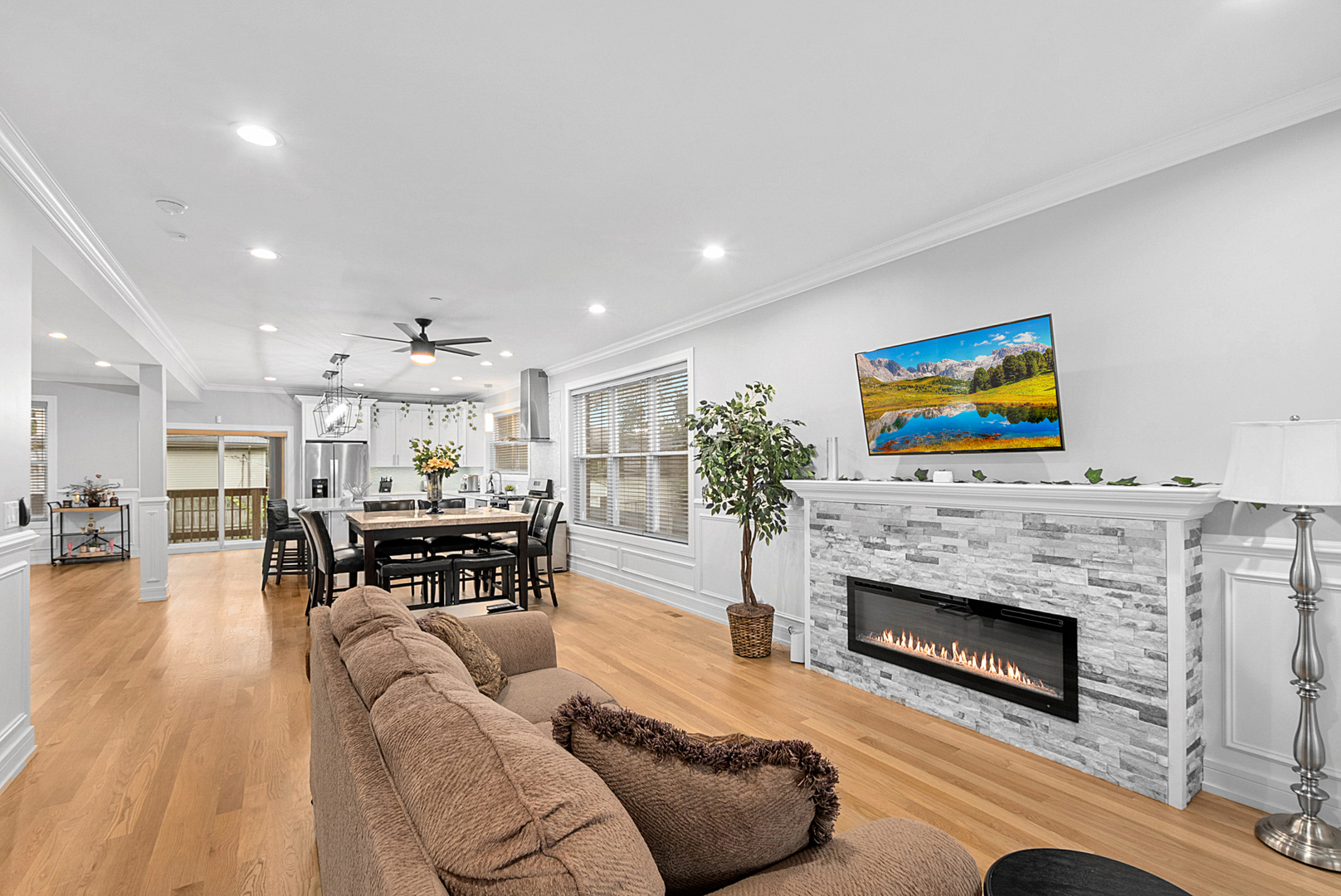 7727 South Roberts Road Bridgeview, IL 60455 - Photo 5 of 36 a living room with furniture a fireplace and a flat screen tv