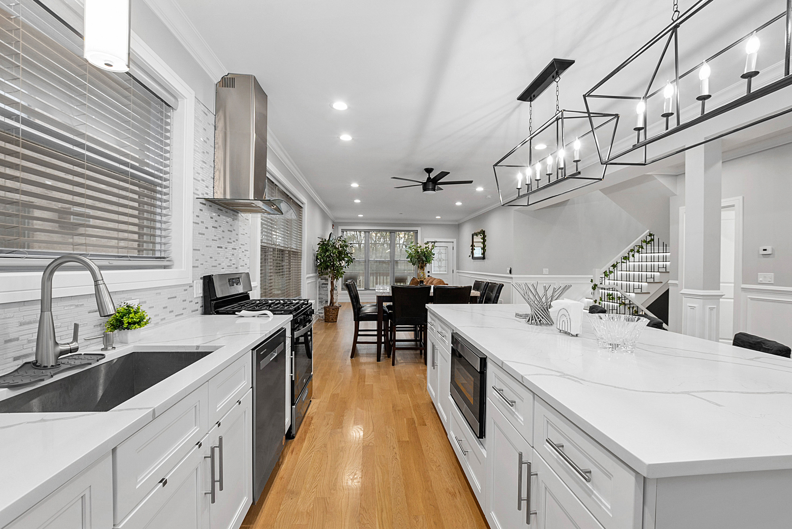 7727 South Roberts Road Bridgeview, IL 60455 - Photo 10 of 36 a large kitchen with kitchen island a large counter space a sink appliances and cabinets