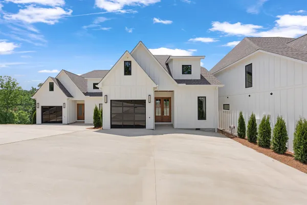 a front view of a house with yard and garage