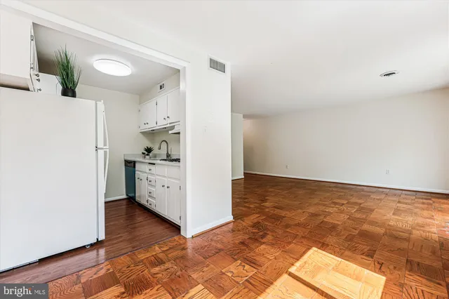 a kitchen with a refrigerator and a sink