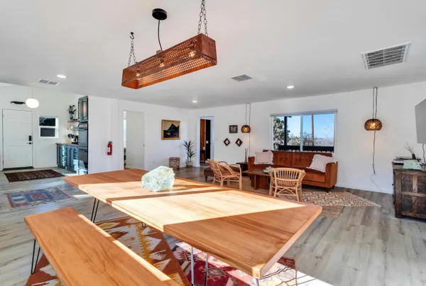 a view of a dining room with furniture window and wooden floor
