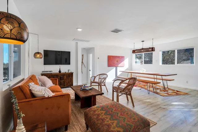 a room with pool table and windows