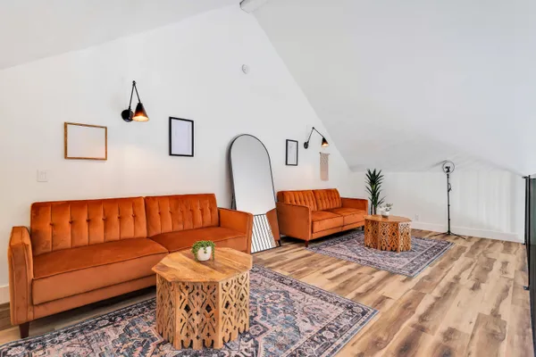 a living room with furniture a fireplace and a chandelier