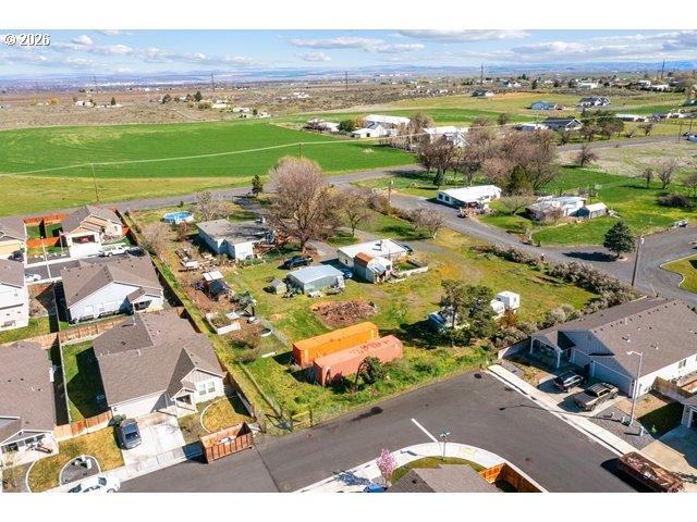 526 East Punkin Center Road Hermiston, OR 97838 - Photo 39 of 48 an aerial view of a city with lots of residential buildings and mountain view in back