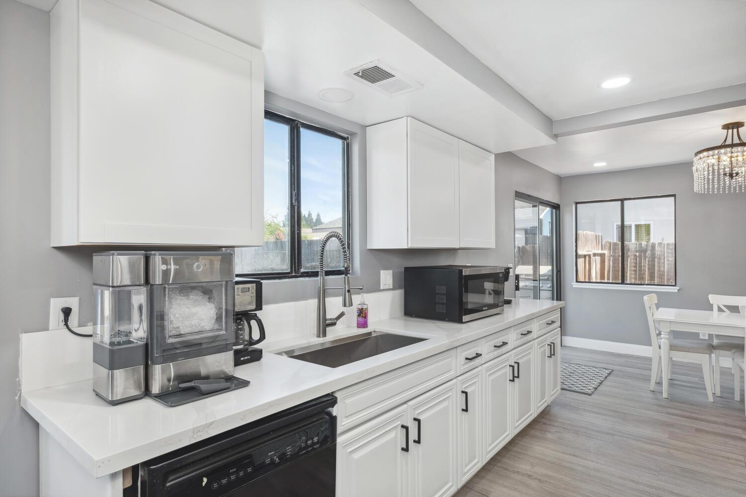 133 Armstrong Avenue Clovis, CA 93611 - Photo 13 of 25 a kitchen with counter top space cabinets and wooden floor