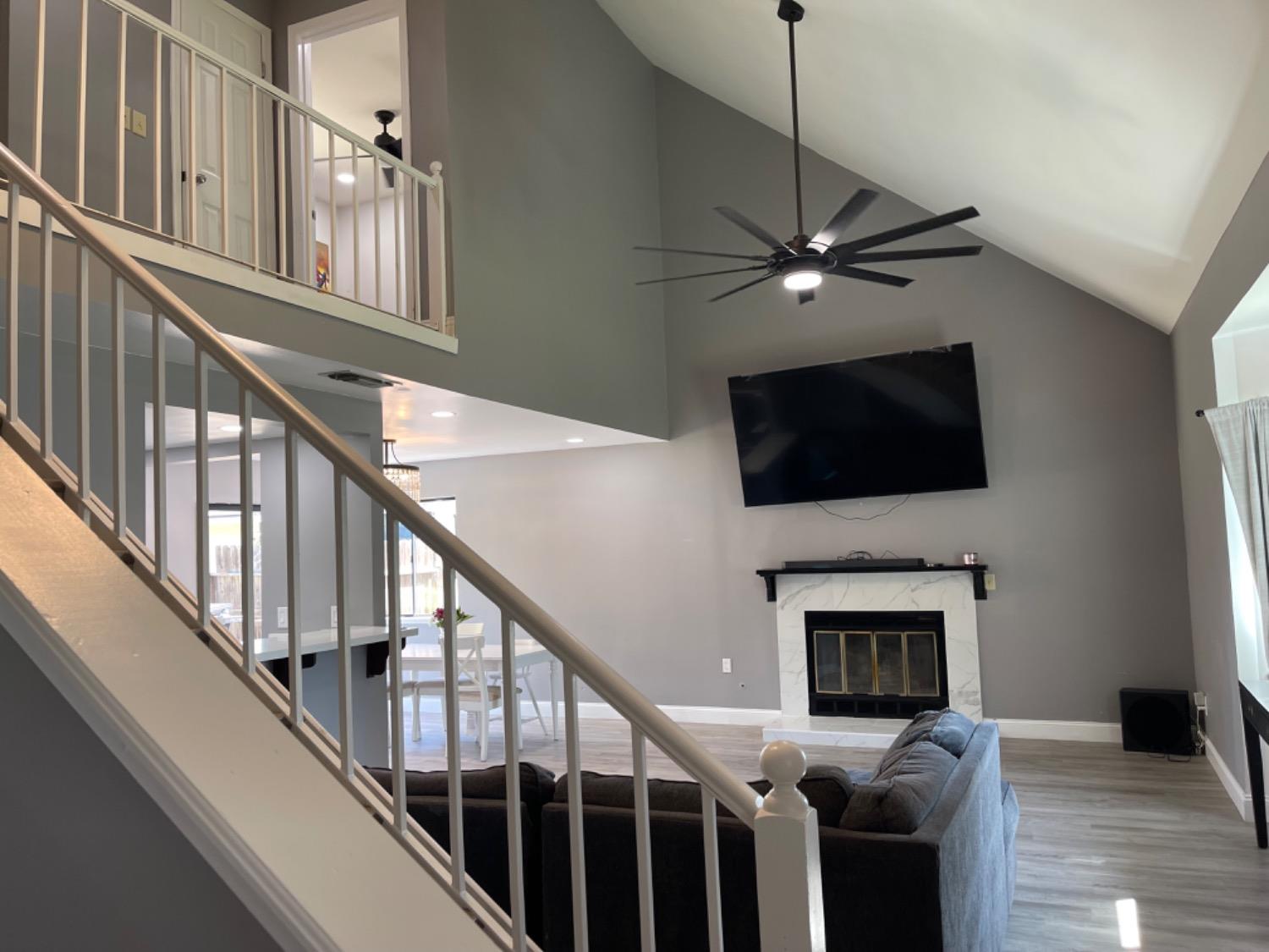133 Armstrong Avenue Clovis, CA 93611 - Photo 17 of 25 a living room with fireplace furniture and a flat screen tv