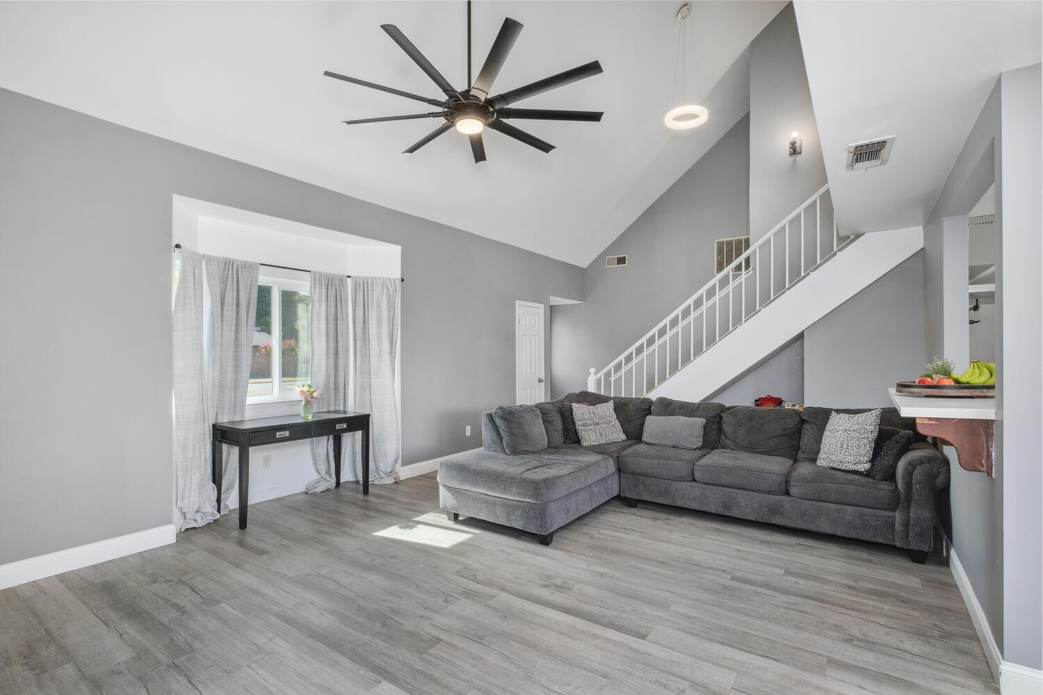 133 Armstrong Avenue Clovis, CA 93611 - Photo 18 of 25 a living room with furniture and a wooden floor
