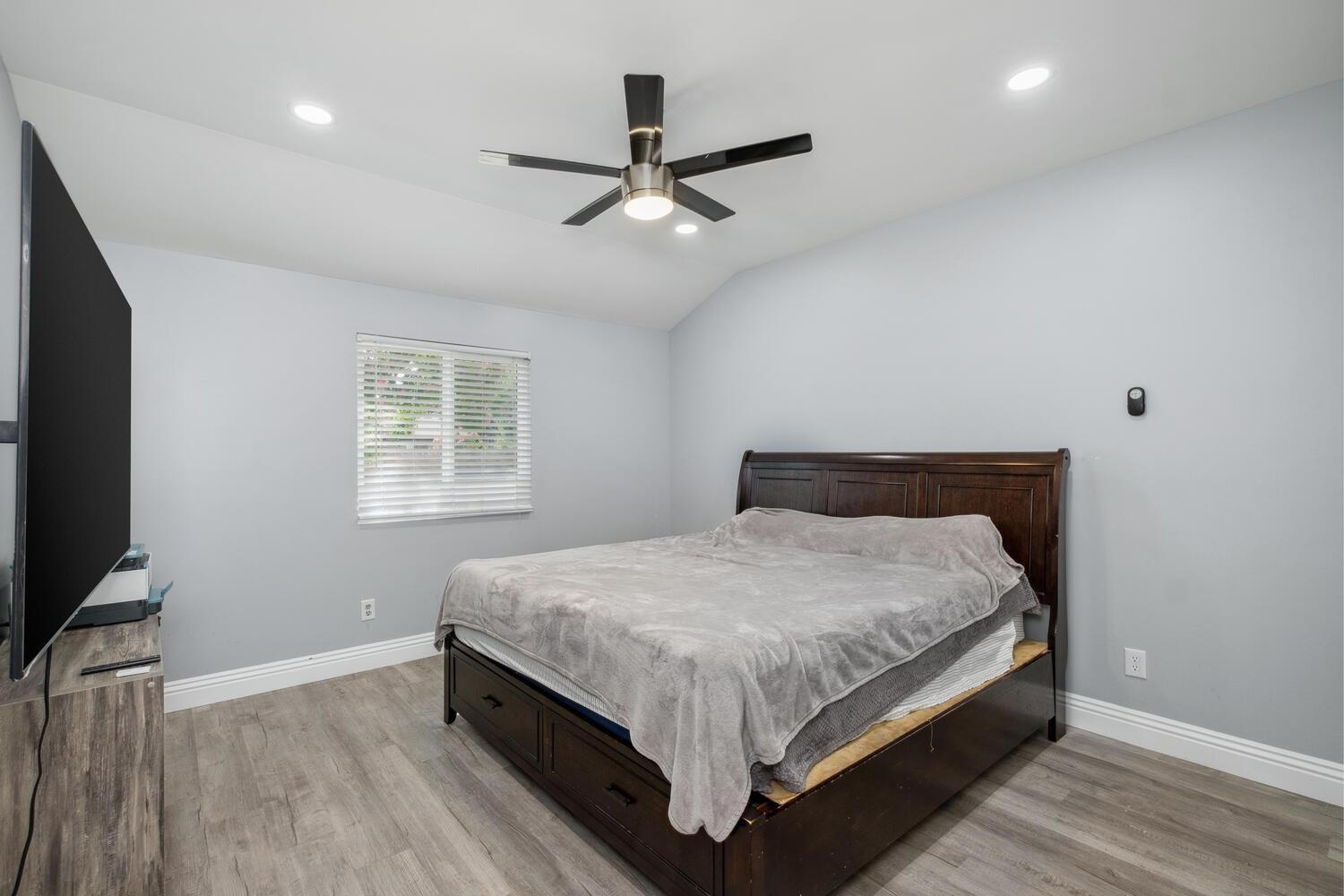 133 Armstrong Avenue Clovis, CA 93611 - Photo 20 of 25 a bedroom with a bed and a flat screen tv