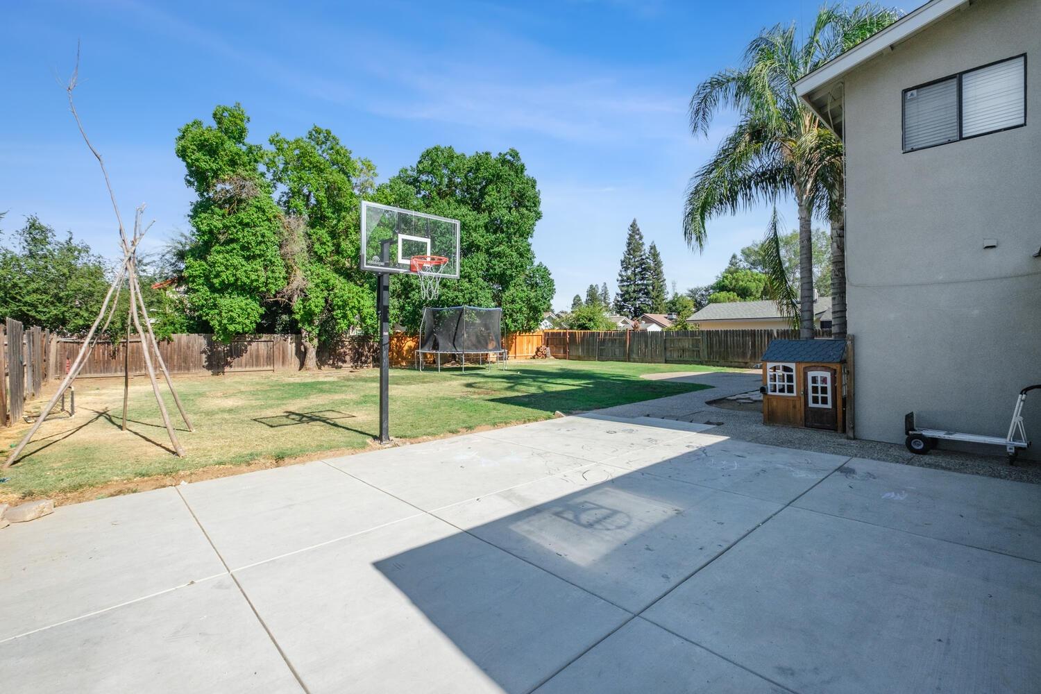 133 Armstrong Avenue Clovis, CA 93611 - Photo 22 of 25 a row of palm trees in front of house