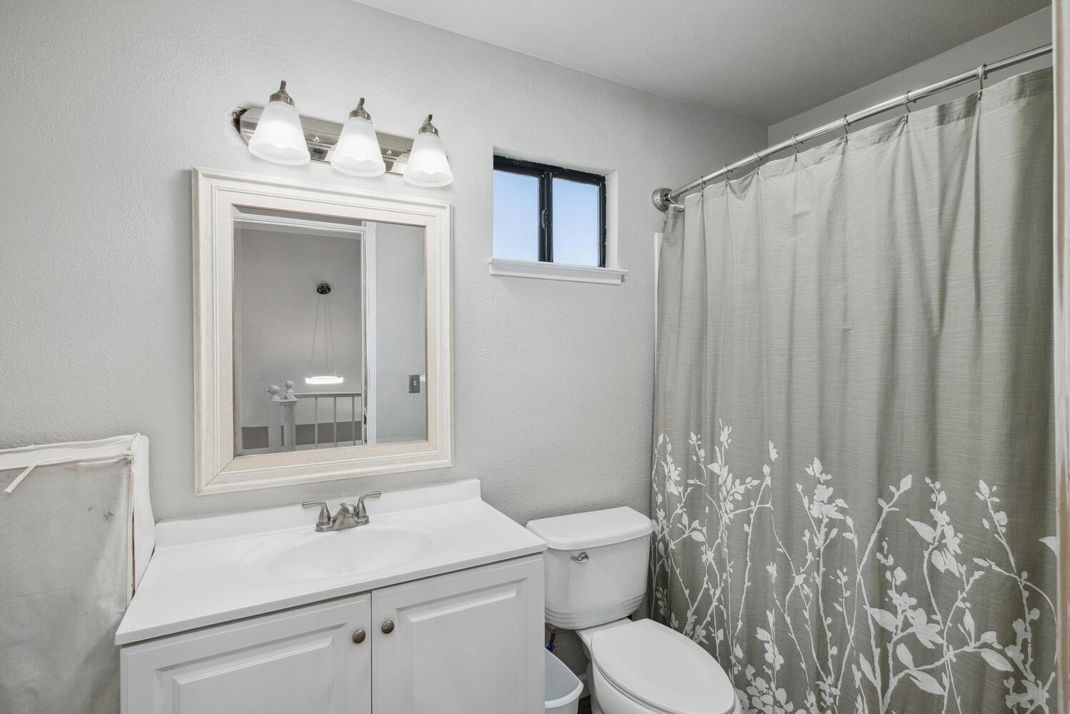 133 Armstrong Avenue Clovis, CA 93611 - Photo 5 of 25 a bathroom with a toilet a sink and a mirror