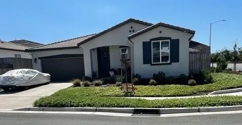 a front view of a house with a yard