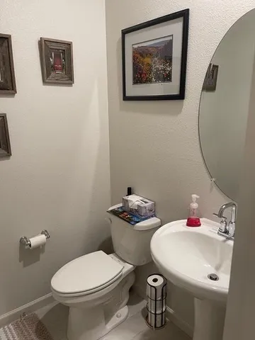 a bathroom with a sink mirror and toilet