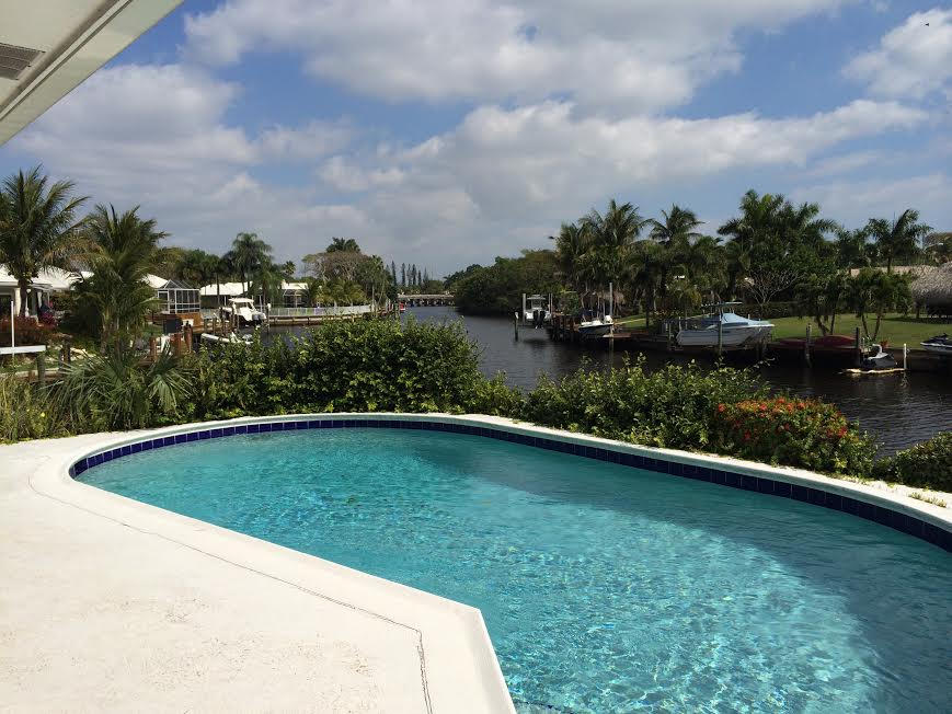 1290 Cypress Way Boca Raton, FL 33486 - Photo 2 of 15 a view of a swimming pool and a yard