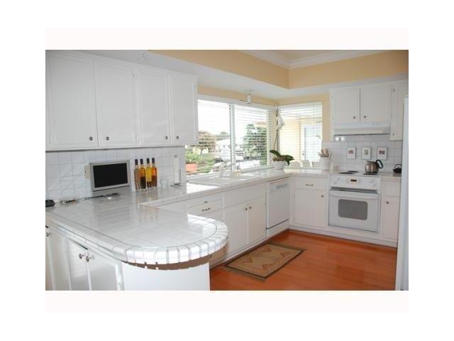 1290 Cypress Way Boca Raton, FL 33486 - Photo 9 of 15 a kitchen with a sink appliances and cabinets