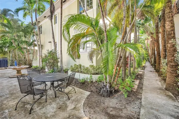 a view of a chairs and table in a backyard