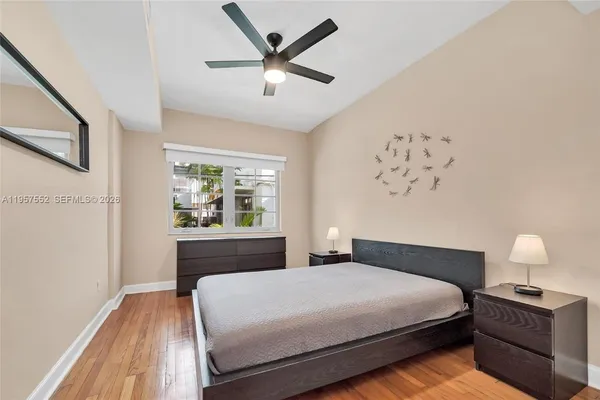 a bedroom with a large bed and a window