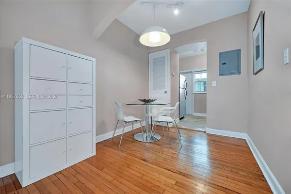 a view of a livingroom with wooden floor and a cabinet