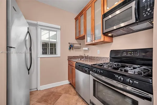 a kitchen with stainless steel appliances granite countertop a stove and a microwave