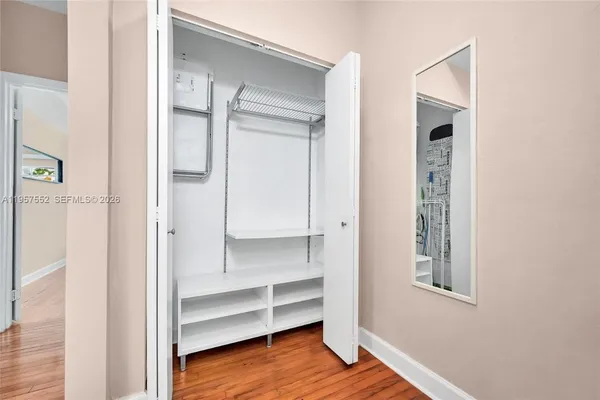 a view of walk in closet with empty racks