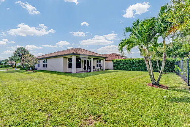 a view of a patio with a table chairs and a yard