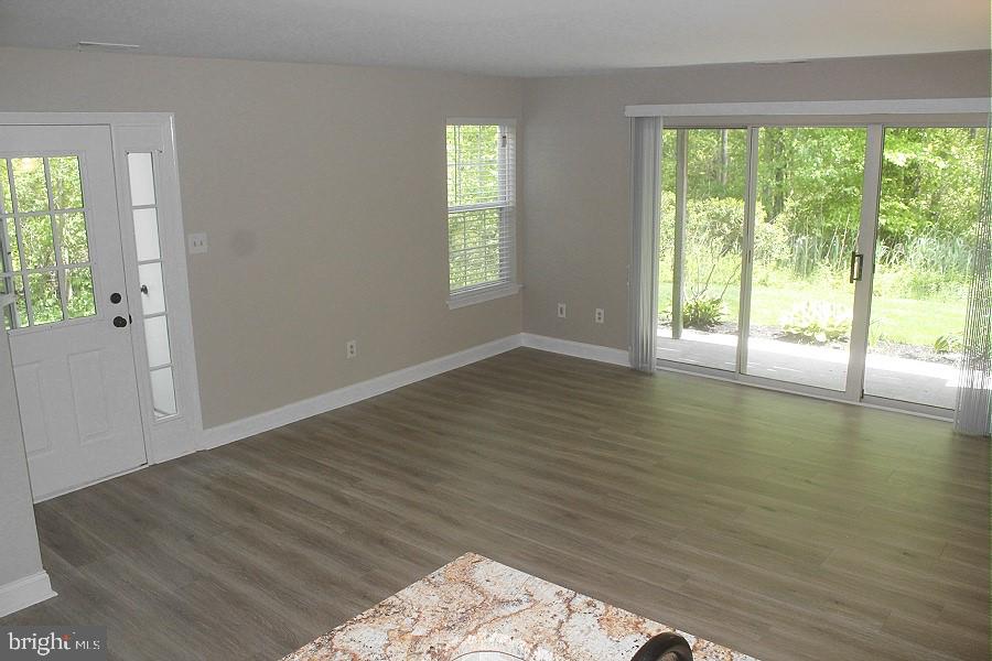 1603 Squirrel Road Marlton, NJ 08053 - Photo 9 of 29 wooden floor in an empty room with a window