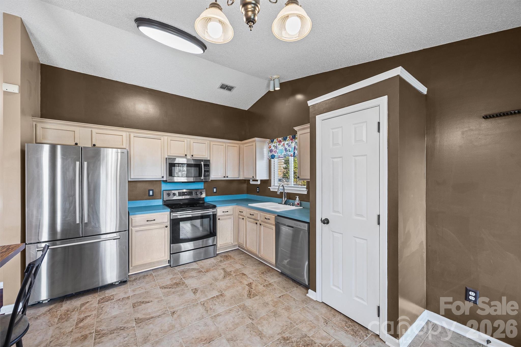 132 Sella Ridge Drive Mount Holly, NC 28120 - Photo 12 of 28 a kitchen with stainless steel appliances granite countertop a refrigerator and a sink