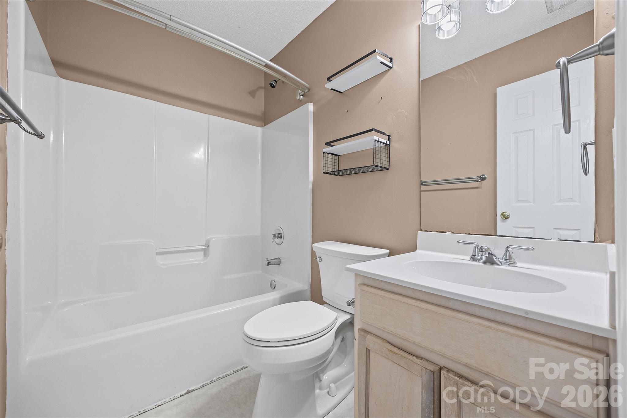 132 Sella Ridge Drive Mount Holly, NC 28120 - Photo 22 of 28 a bathroom with a sink a toilet and shower