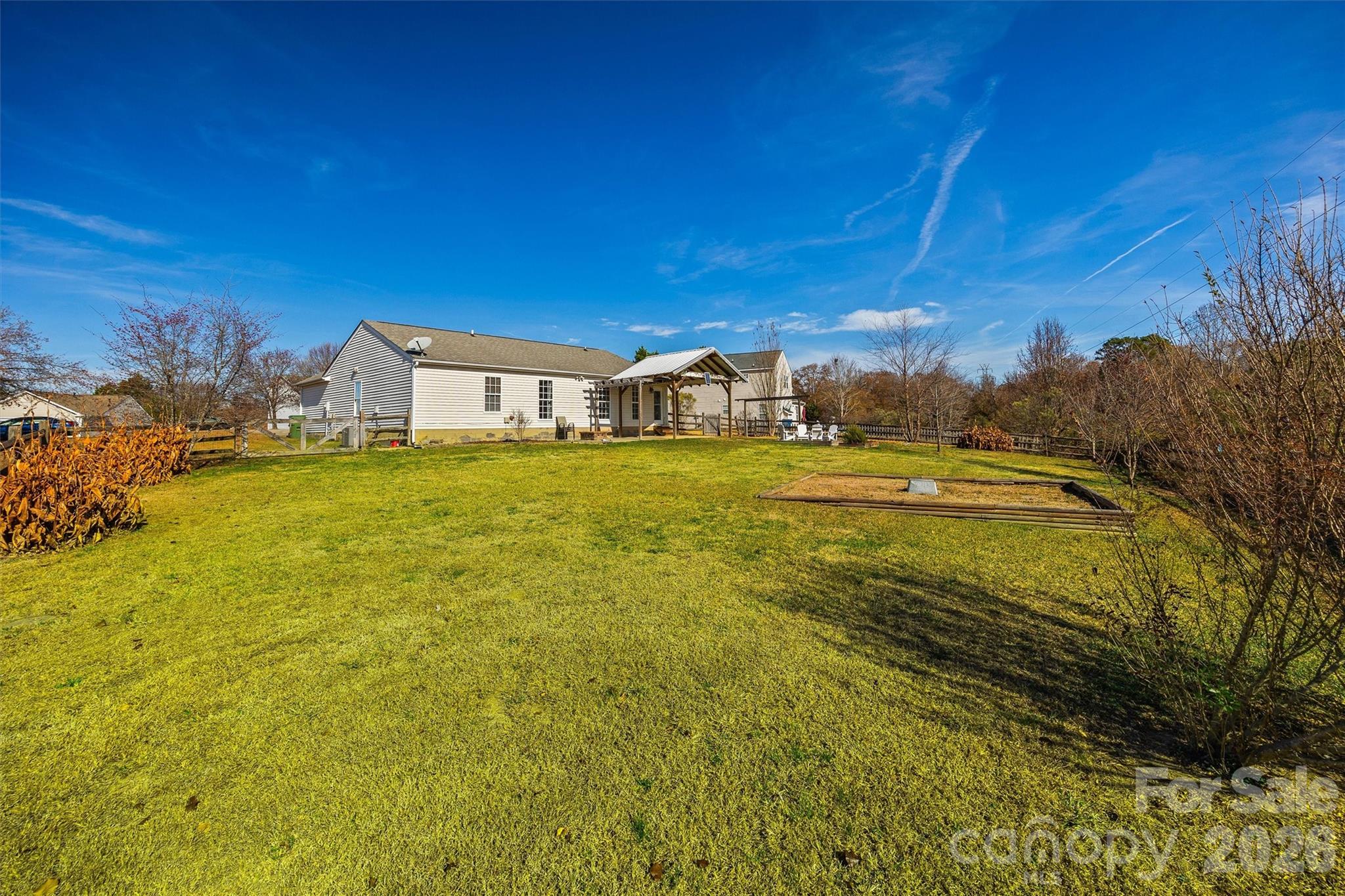 132 Sella Ridge Drive Mount Holly, NC 28120 - Photo 26 of 28 a view of a large pool with lawn chairs under an umbrella