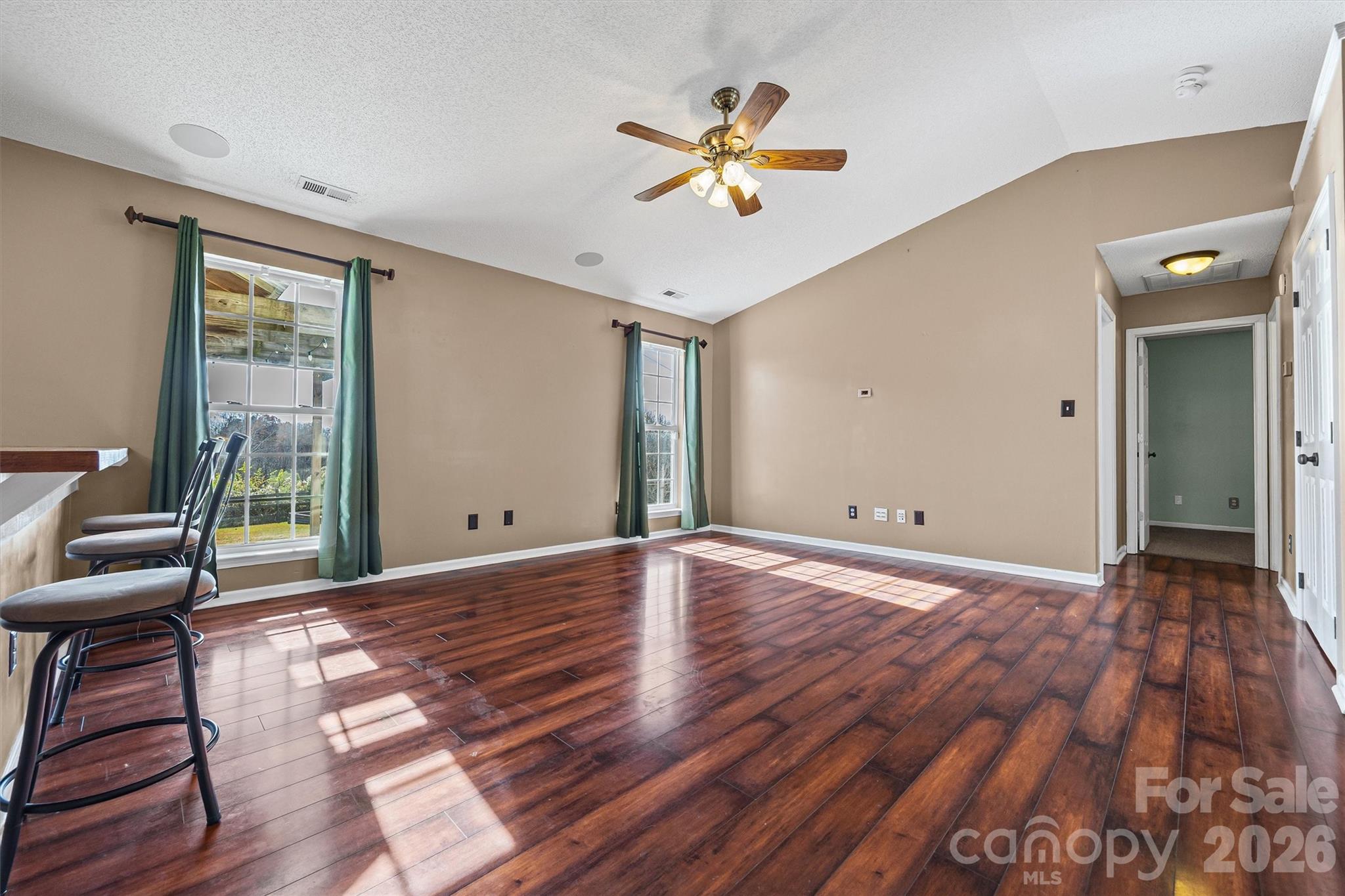 132 Sella Ridge Drive Mount Holly, NC 28120 - Photo 6 of 28 a view of a livingroom with wooden floor and a ceiling fan