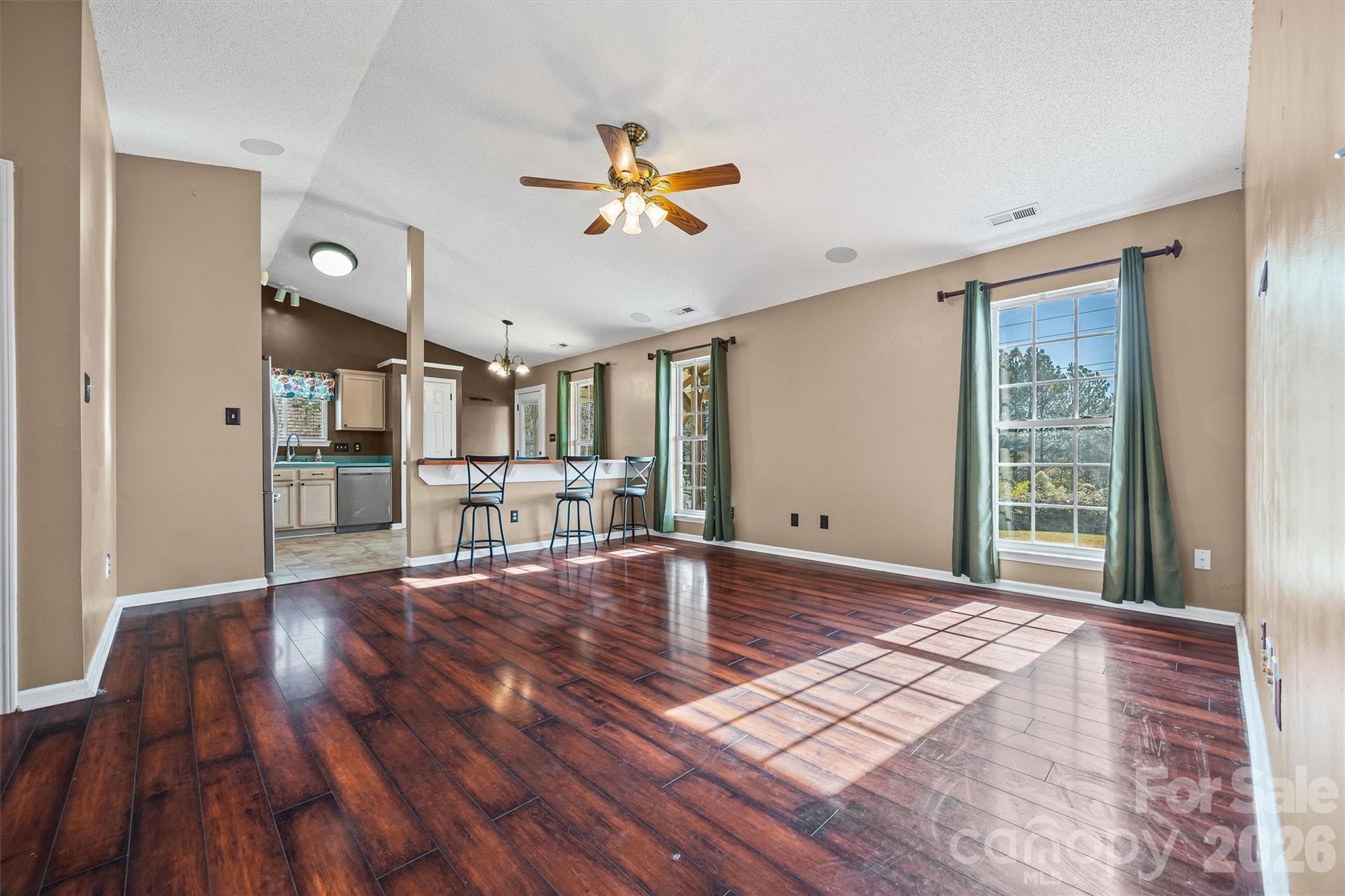 132 Sella Ridge Drive Mount Holly, NC 28120 - Photo 8 of 28 a view of an empty room with wooden floor and a window