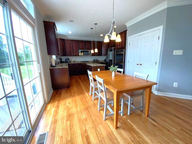 320 Kennard Road Perkasie, PA 18944 - Photo 7 of 29 a view of a dining room with furniture a chandelier and wooden floor