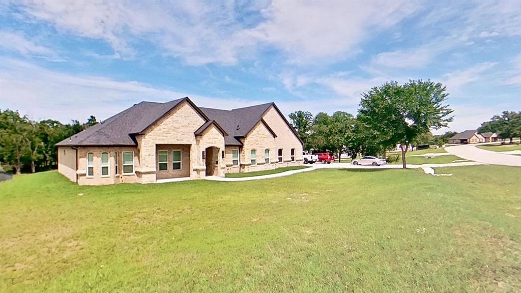3248 North Cardinal Road Azle, TX 76020 - Photo 5 of 29 Contemporary brick exterior featuring a multi-gabled roofline, arched entry, and white-framed windows