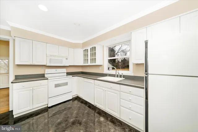a kitchen with sink and cabinets