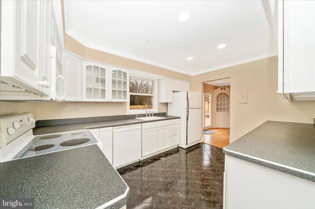 a large kitchen with stainless steel appliances granite countertop a sink and a stove