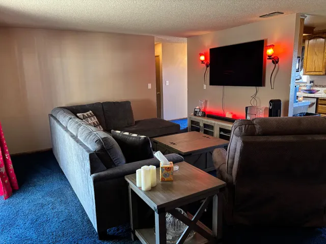 a kitchen with stainless steel appliances granite countertop a refrigerator and a stove