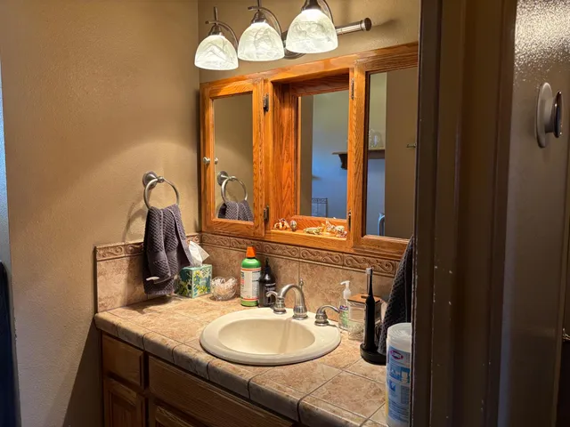 a bathroom with a sink vanity and a mirror