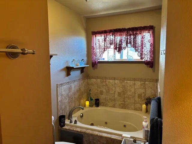 an empty room with a window and a ceiling fan