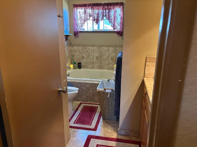 an empty room with wooden floor and closet