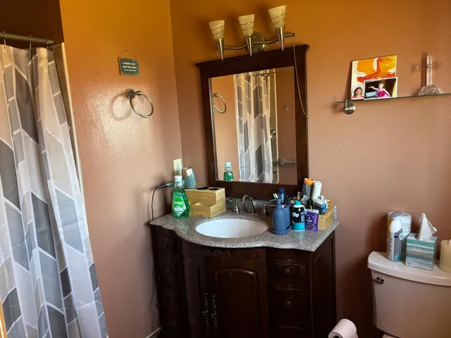 a view of a small space with wooden floor and a window