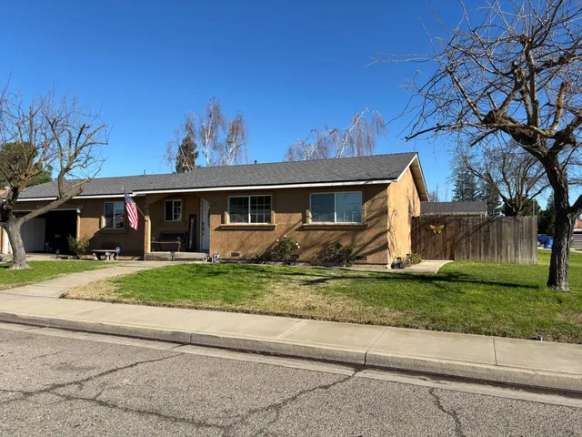 a front view of house with a garden
