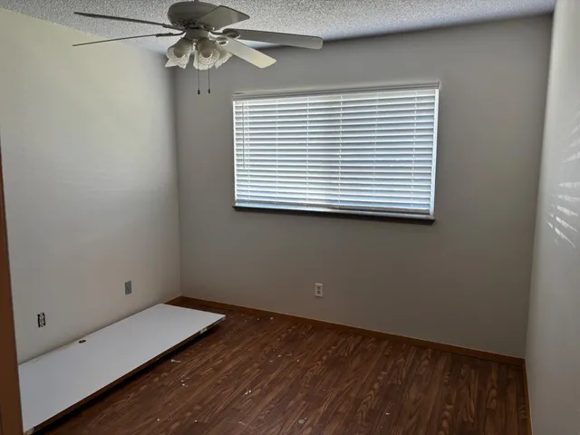 a view of a hallway with wooden floor and closet