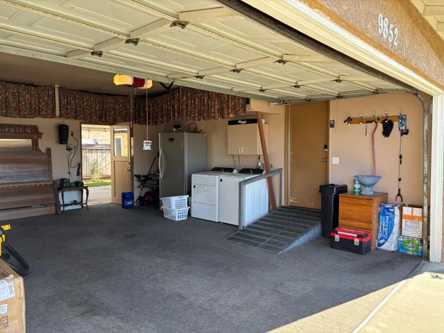 a view of a chairs and tables in the back yard of the house