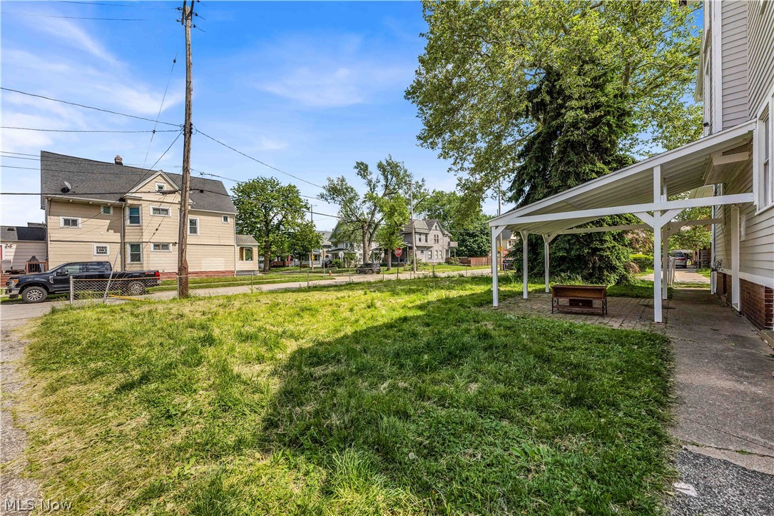 3506 Riverside Avenue Cleveland, OH 44109 - Photo 28 of 31 Side yard with a covered patio featuring a paver base, white support columns, and a solid roof