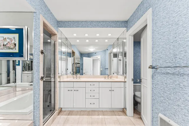 a bathroom with a bathtub shower sink and mirror