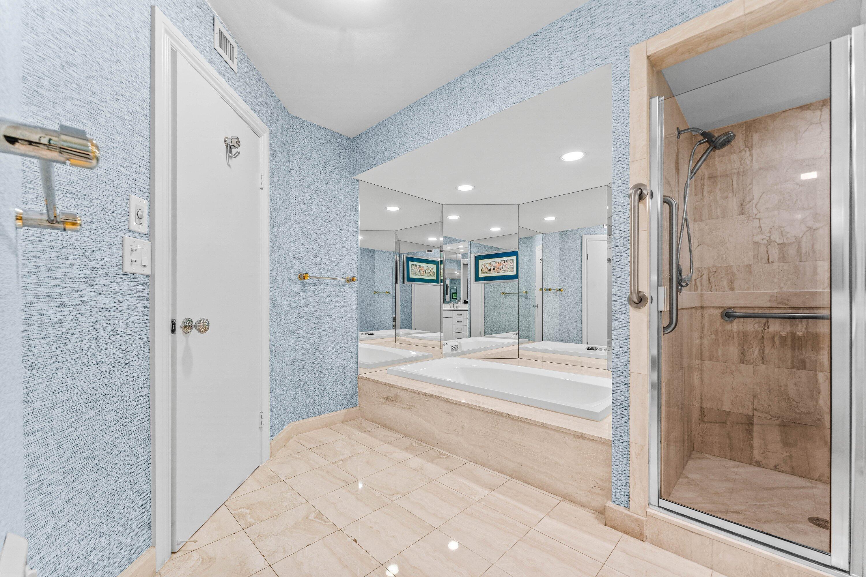 3170 South Ocean Boulevard, Unit S302 Palm Beach, FL 33480 - Photo 12 of 34 a bathroom with a bathtub shower sink and mirror