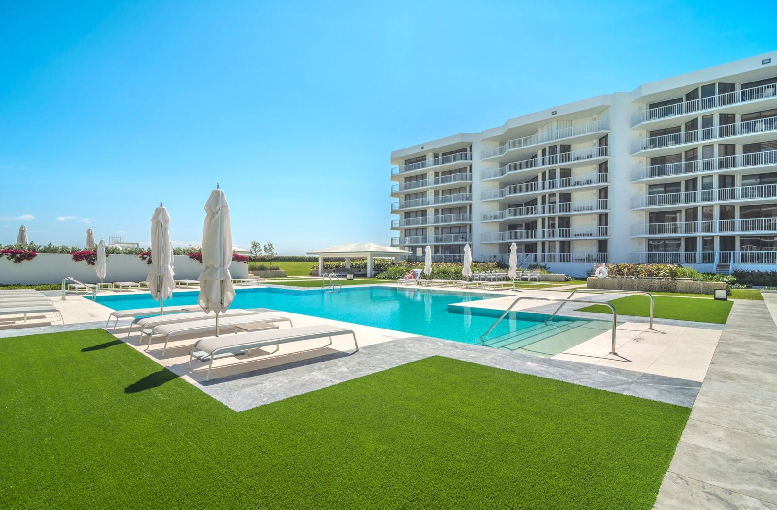 3170 South Ocean Boulevard, Unit S302 Palm Beach, FL 33480 - Photo 18 of 34 a swimming pool with outdoor seating and yard