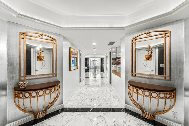 a kitchen with granite countertop white cabinets and chandelier