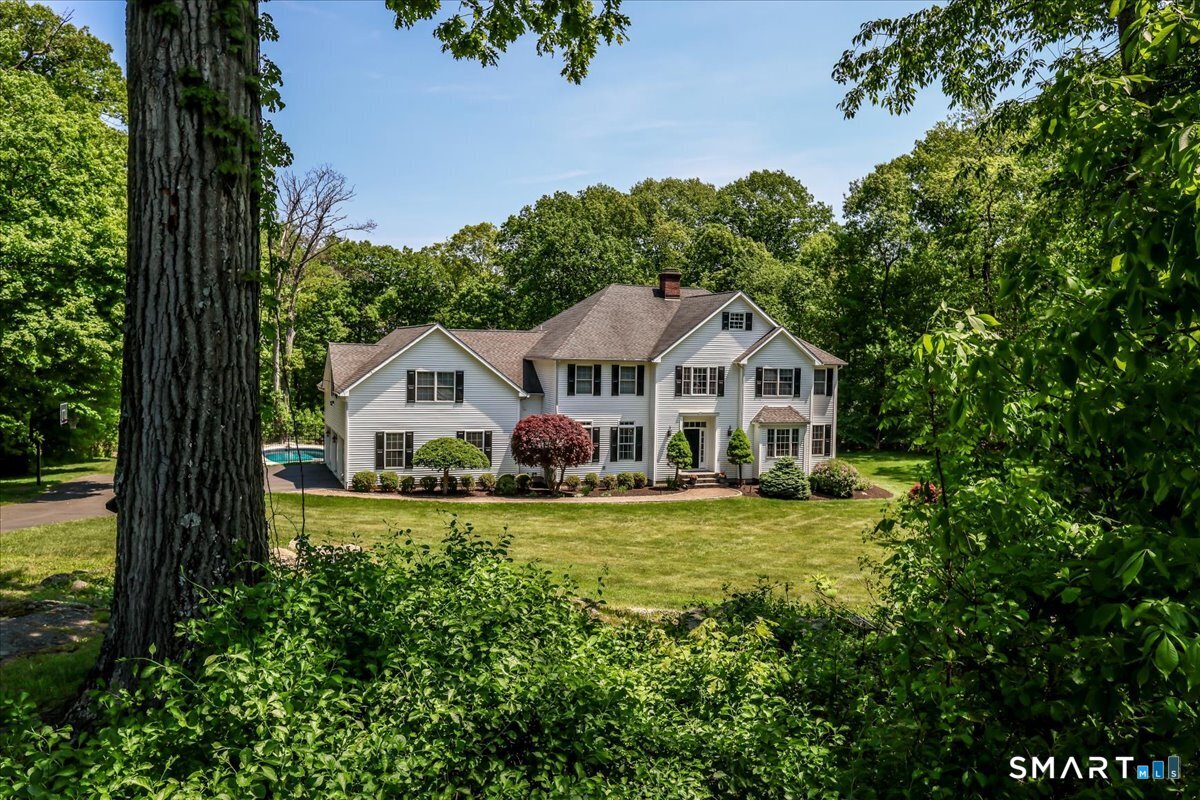 8 Rock Ridge Court New Fairfield, CT 06812 - Photo 2 of 39 a front view of a house with a yard