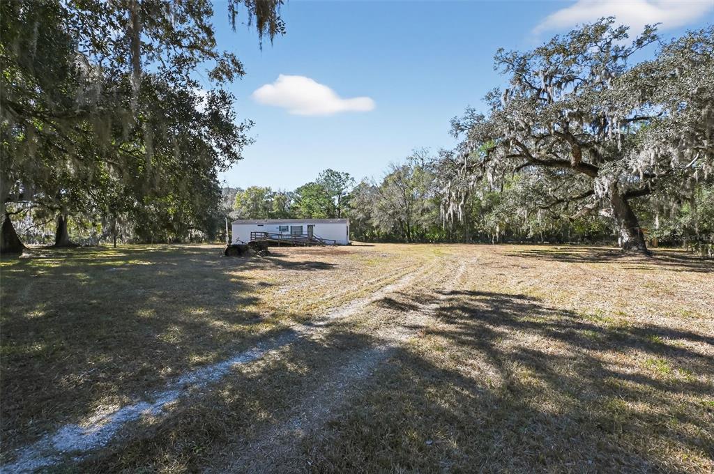 7405 Bonnie Lake Road Brooksville, FL 34601 - Photo 3 of 14 a view of swimming pool with a yard